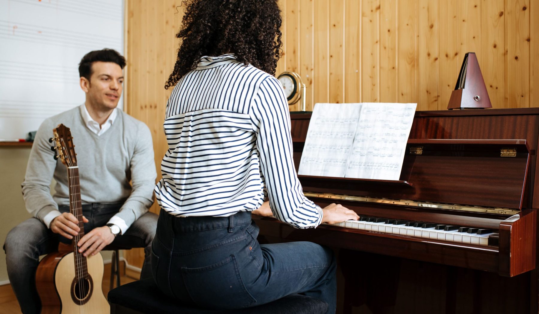 woman-playing-piano-near-man-playing-guitar-in-stu-2026-03-25-01-21-47-utc